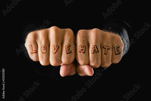 Photo: Love and hate tattooes, hands clenched in fist Love and hate tattooes, hands clenched in fist