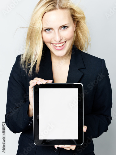 Photo: Business woman presenting her tablet with copyspace Business woman presenting her tablet with copyspace