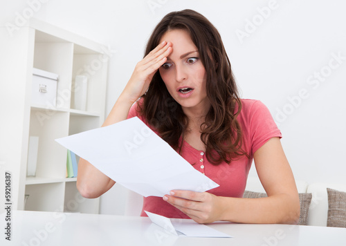 Photo: Sad Woman Reading Paper Sad Woman Reading Paper