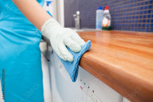 Photo: Woman Cleaning Kitchen Countertop Woman Cleaning Kitchen Countertop