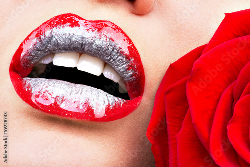 Photo: beautiful female lips with shiny lipstick and red rose beautiful female lips with shiny lipstick and red rose