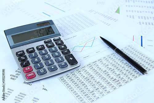 Photo: Calculator and pen with documents close up Calculator and pen with documents close up
