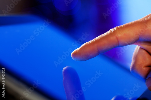 Photo: Finger touching screen Finger touching screen