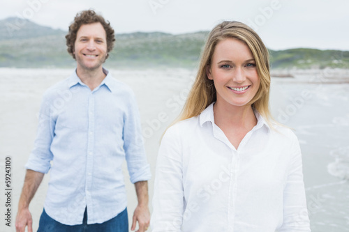 Photo: Smiling casual young couple at beach Smiling casual young couple at beach