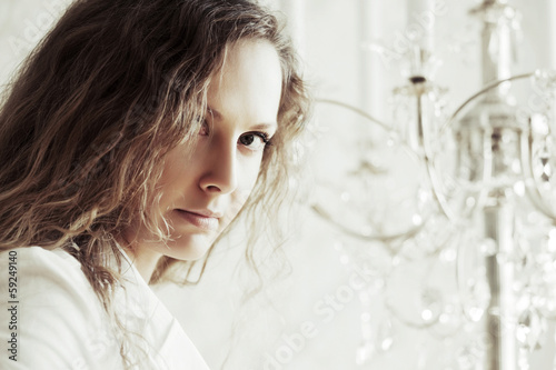 Photo: Sad beautiful woman with long curly hairs Sad beautiful woman with long curly hairs