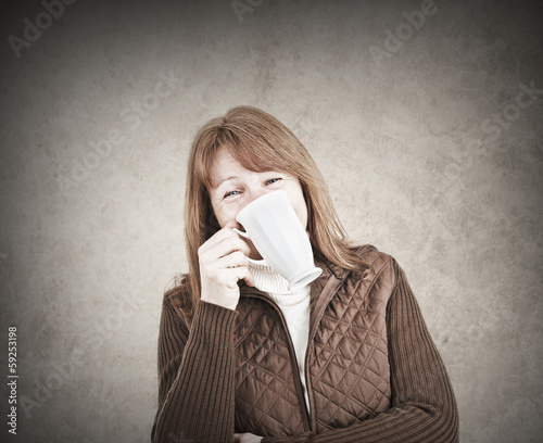 Photo: Funny woman laughing with a mug in her hand Funny woman laughing with a mug in her hand