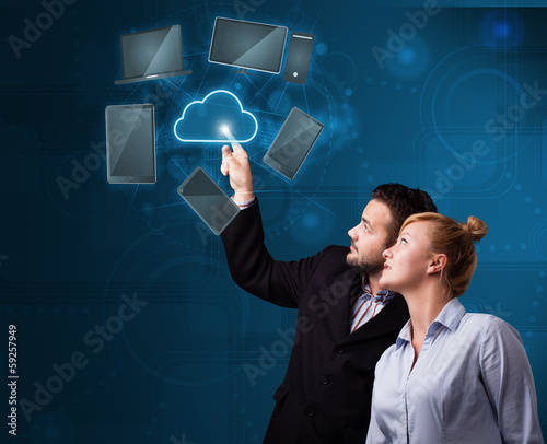 Photo: Happy couple touching cloud service Happy couple touching cloud service