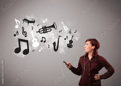 Photo: Beautiful young woman singing and listening to music with musica Beautiful young woman singing and listening to music with musica