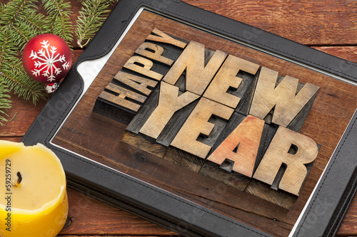 Photo: happy new year on digital tablet happy new year on digital tablet