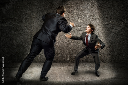 Photo: two businessmen fighting as sumoist two businessmen fighting as sumoist