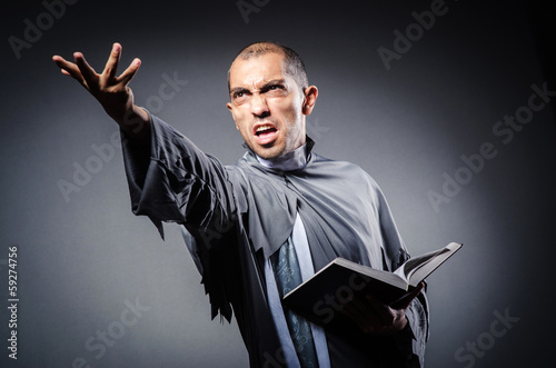 Photo: Young priest isolated on the white Young priest isolated on the white