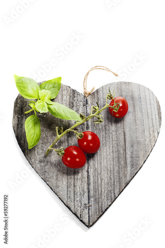 Photo: Fresh vegetables on heart shaped cutting board Fresh vegetables on heart shaped cutting board