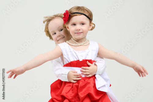 Photo: Little boy embraces happy girl with outstretched arms Little boy embraces happy girl with outstretched arms