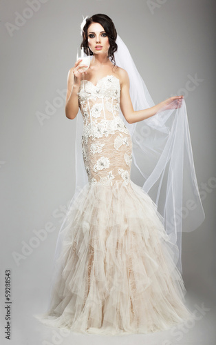 Photo: Fashionable Woman in White Dress holding Wineglass of Champagne Fashionable Woman in White Dress holding Wineglass of Champagne