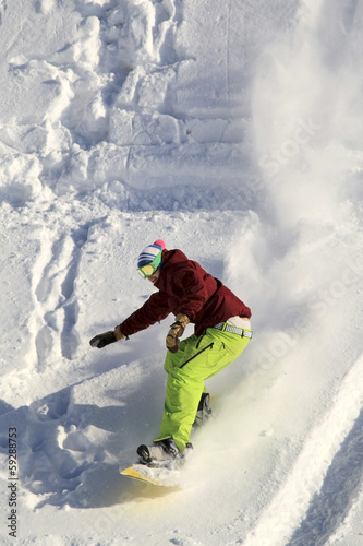 Photo: Snowboarder moving down Snowboarder moving down