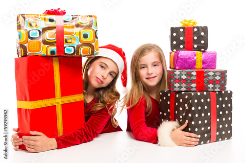 Photo: Christmas Santa kid girls with many gifts stacked Christmas Santa kid girls with many gifts stacked