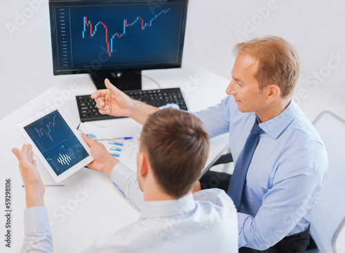 Photo: businessmen with notebook and tablet pc businessmen with notebook and tablet pc