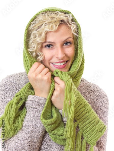 Photo: Portrait of a smiling woman wrapped with wool scarf and cap Portrait of a smiling woman wrapped with wool scarf and cap
