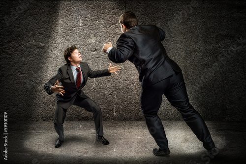 Photo: two businessmen fighting as sumoist two businessmen fighting as sumoist