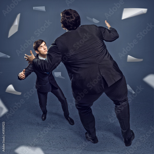 Photo: two businessmen fighting as sumoist two businessmen fighting as sumoist