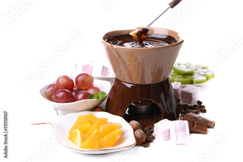 Photo: Chocolate fondue with marshmallow candies and fruits, isolated Chocolate fondue with marshmallow candies and fruits, isolated