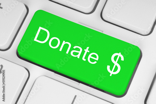 Photo: Green donate button on the keyboard close-up . Green donate button on the keyboard close-up .