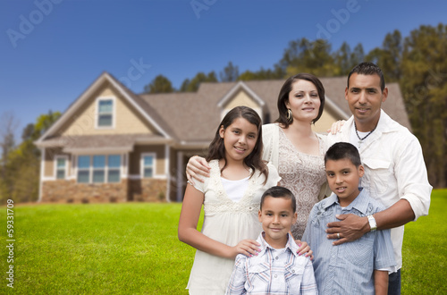 Photo: Young Hispanic Family in Front of Their New Home Young Hispanic Family in Front of Their New Home