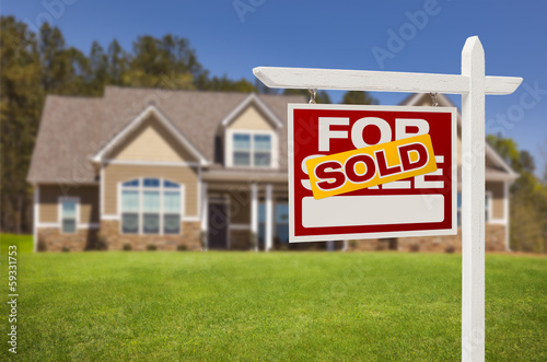 Photo: Sold Home For Sale Sign in Front of New House Sold Home For Sale Sign in Front of New House