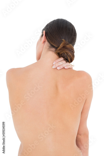 Photo: Rear view of a topless fit woman with shoulder pain Rear view of a topless fit woman with shoulder pain