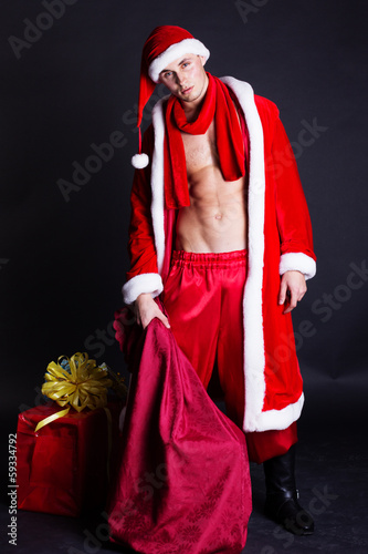 Photo: Young man wearing like Santa clause. Christmas Young man wearing like Santa clause. Christmas