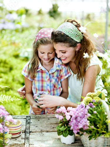 Photo: Mom and daughter have fun in the work of gardening Mom and daughter have fun in the work of gardening