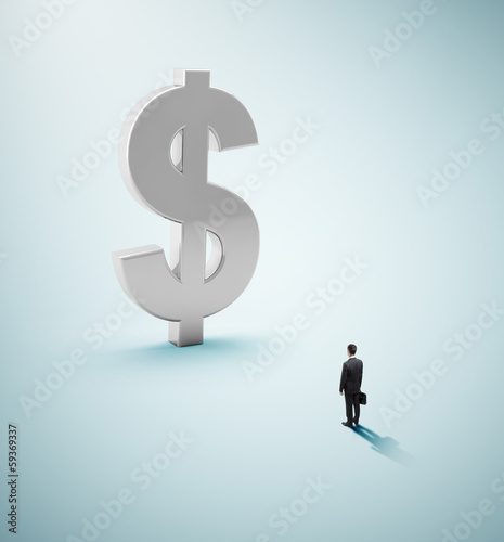 Photo: businessman looking at dollar businessman looking at dollar