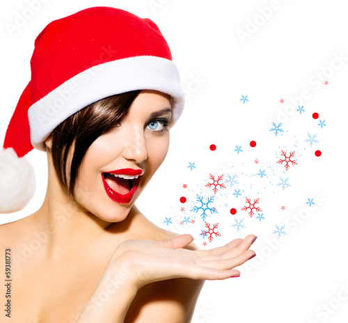 Photo: Christmas Woman. Beauty Girl in Santa Hat isolated on White Christmas Woman. Beauty Girl in Santa Hat isolated on White