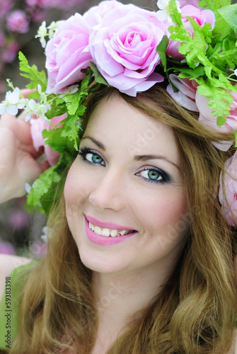 Photo: Beautiful girl in a flowered garden peach Beautiful girl in a flowered garden peach