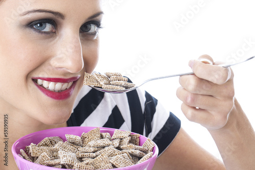 Photo: Young Woman Eating Breakfast Cereal Young Woman Eating Breakfast Cereal
