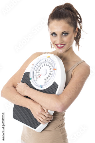 Photo: Young Woman Holding Bathroom Scales Young Woman Holding Bathroom Scales