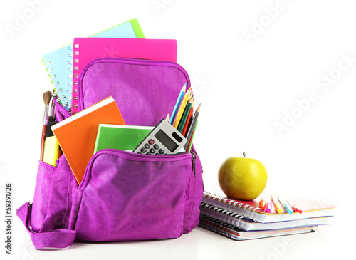 Photo: Purple backpack with school supplies isolated on white Purple backpack with school supplies isolated on white