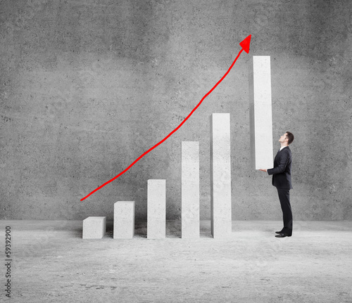 Photo: businessman holding graph businessman holding graph