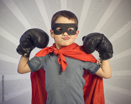 Photo: Superhero kid wearing boxing gloves Superhero kid wearing boxing gloves