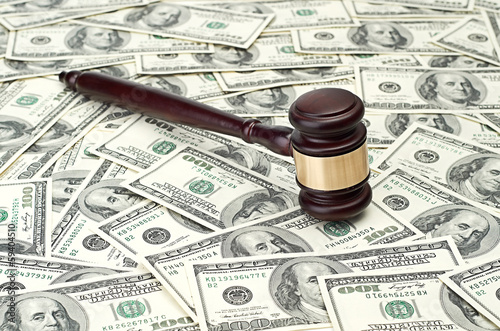 Photo: gavel on dollar background gavel on dollar background