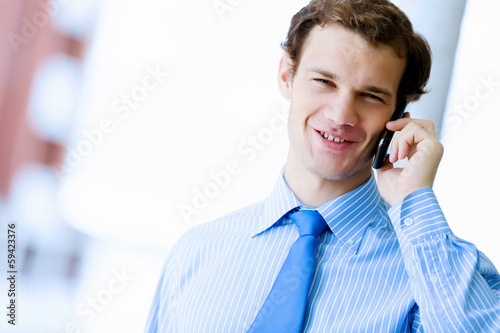 Photo: Businessman speaking mobile phone Businessman speaking mobile phone