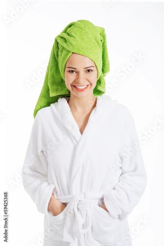 Photo: Beautiful spa woman in bathrobe and turban. Beautiful spa woman in bathrobe and turban.