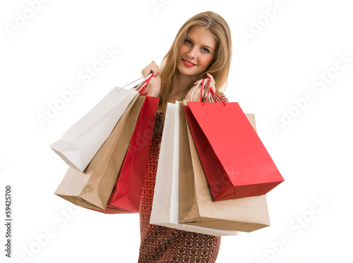 Photo: Shopping woman holding shopping bags looking at camera Shopping woman holding shopping bags looking at camera