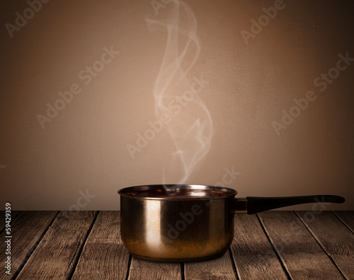 Photo: pot on old wooden table pot on old wooden table