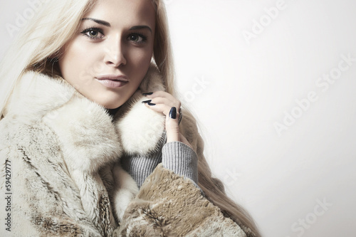 Photo: Beautiful blond woman in Fur Coat.Winter fashion.text here Beautiful blond woman in Fur Coat.Winter fashion.text here