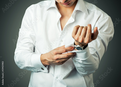 Photo: Sexy man buttons cuff-link on French cuffs Sexy man buttons cuff-link on French cuffs