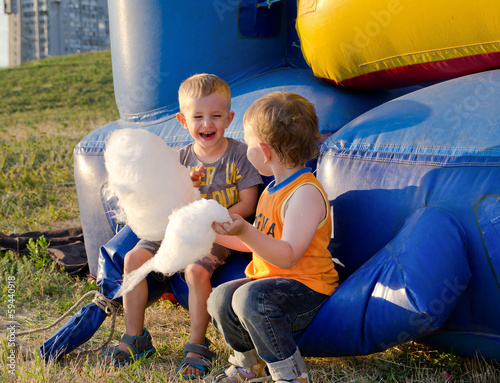 Photo: Two little boys eating candy floss Two little boys eating candy floss