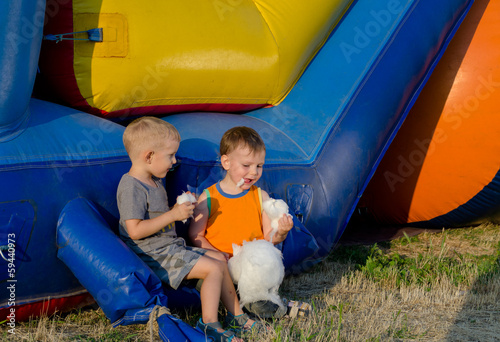 Photo: Two young friends eating candy floss Two young friends eating candy floss