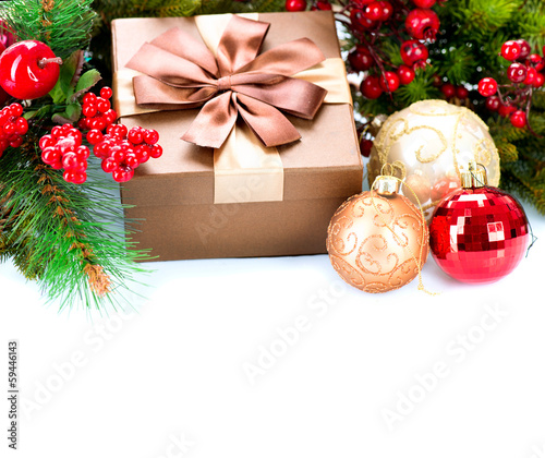 Photo: Christmas Decorations and Gift Box Isolated on White Christmas Decorations and Gift Box Isolated on White