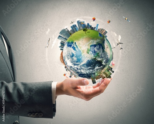 Photo: Businessman holds modern World Businessman holds modern World
